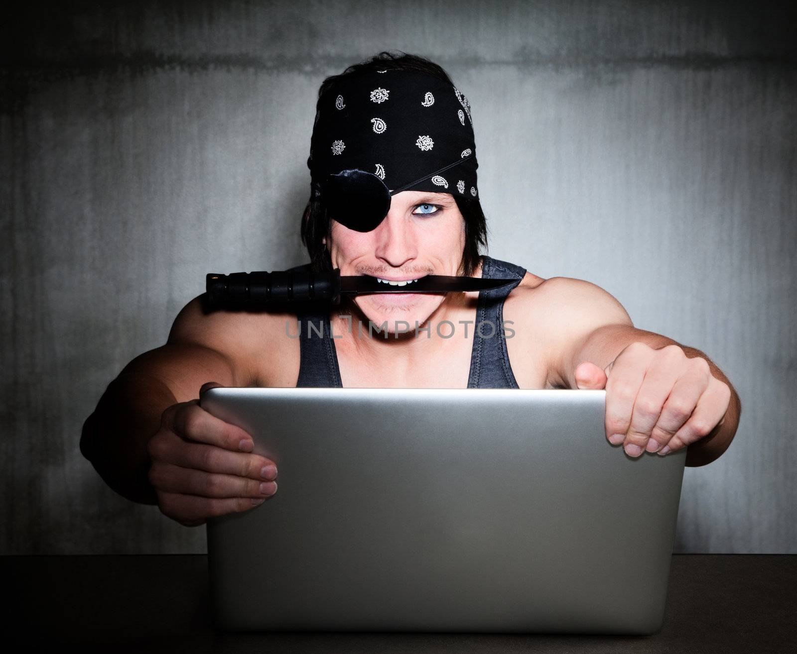 Concept shot of man with knife as Internet pirate