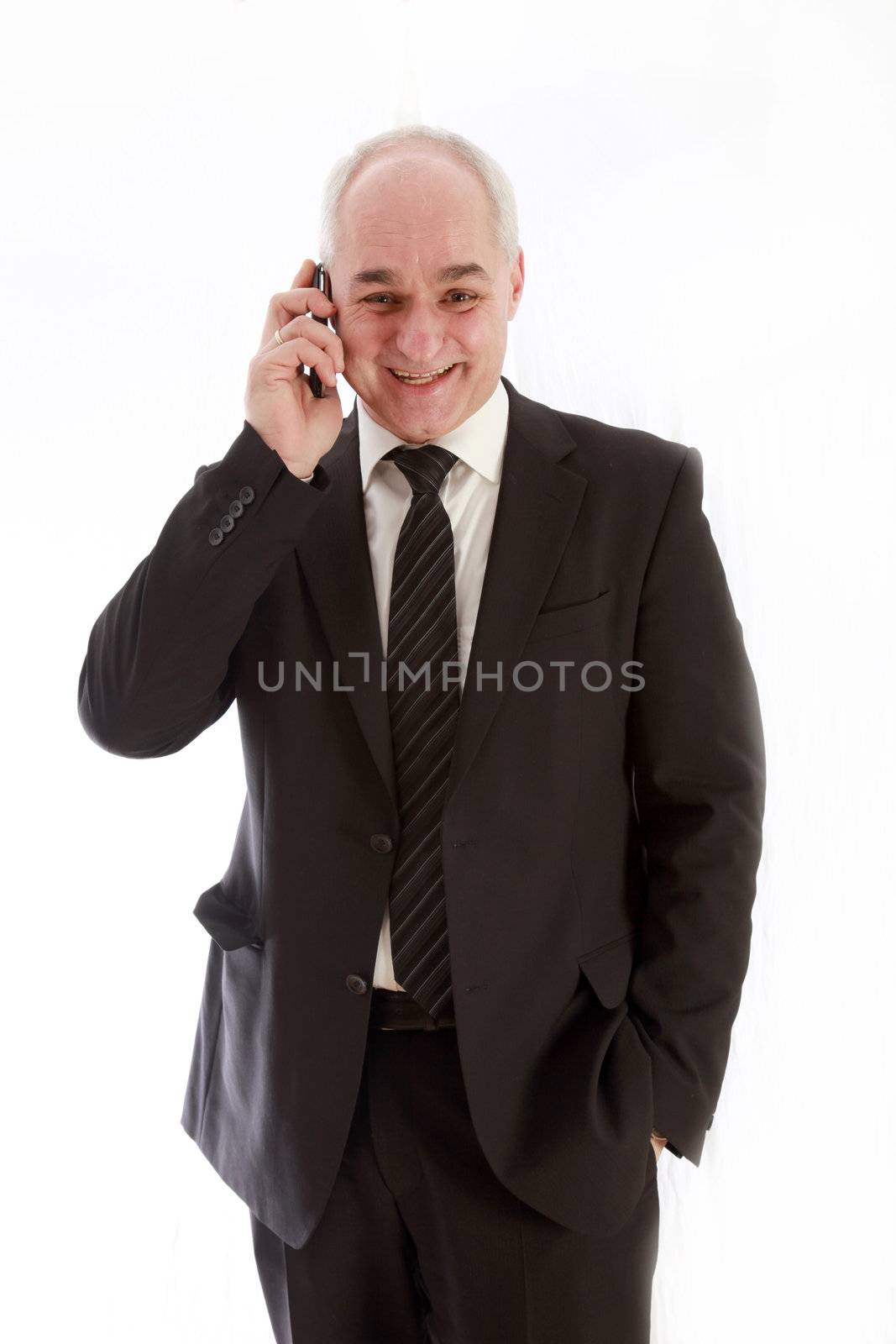 Laughing, older businessman in a suit and has telephoned  by Farina6000