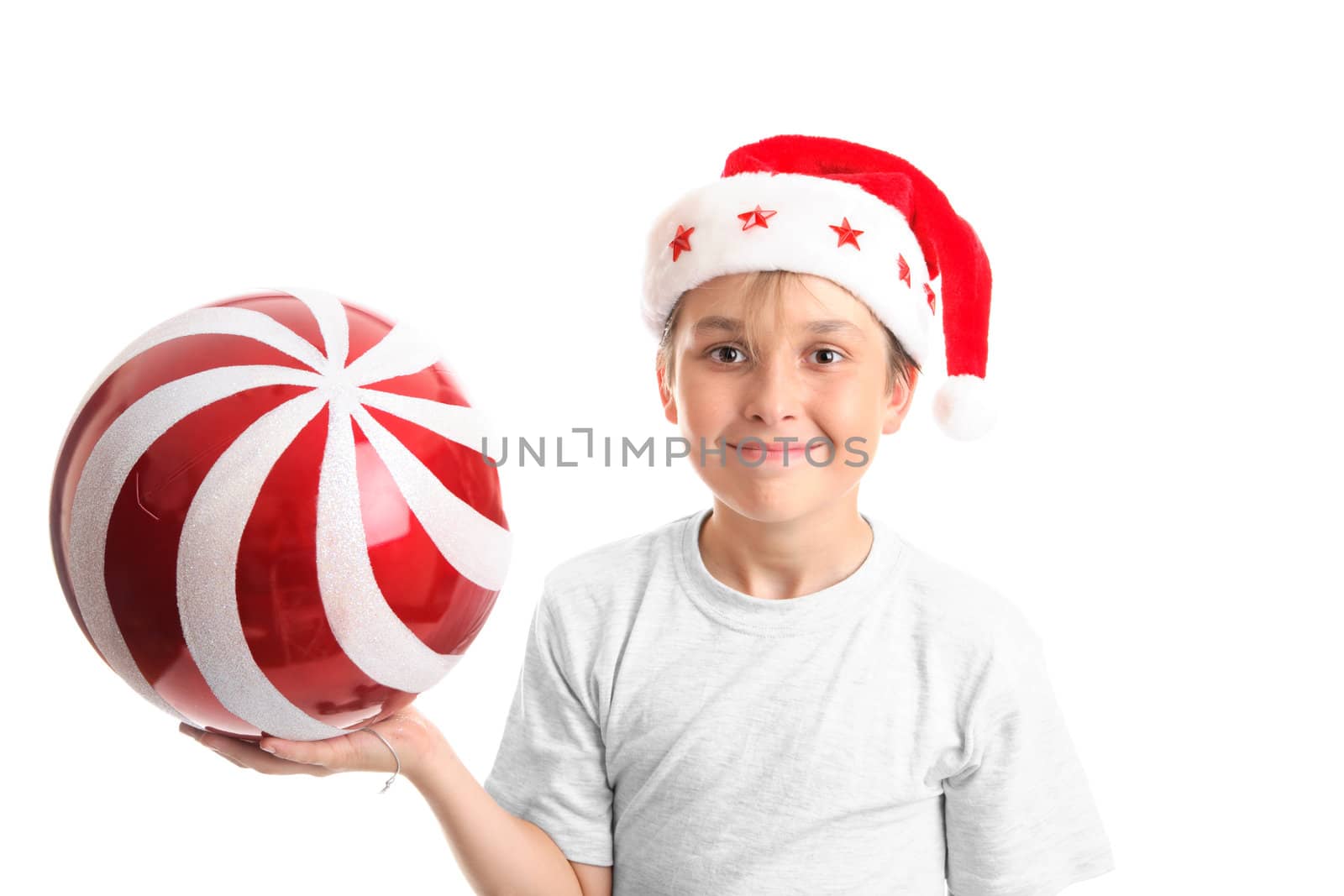 Boy holding a large red Christmas bauble with glitter swirls