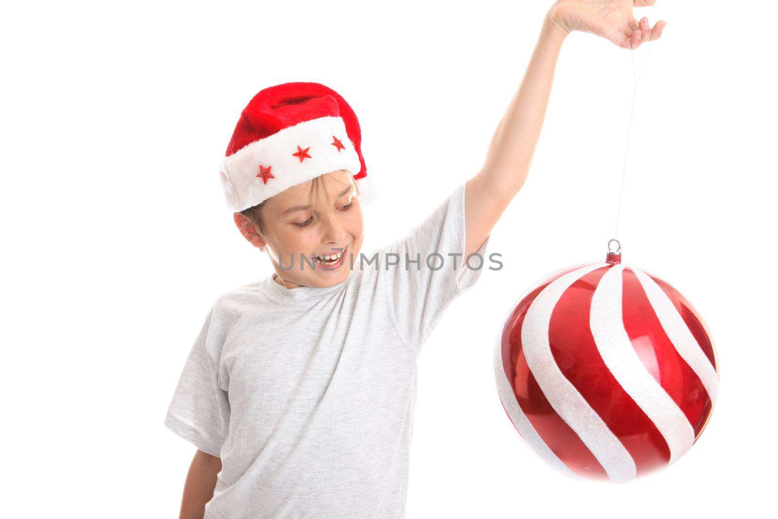 A child watches a large Christmas  bauble spin around with much delight..