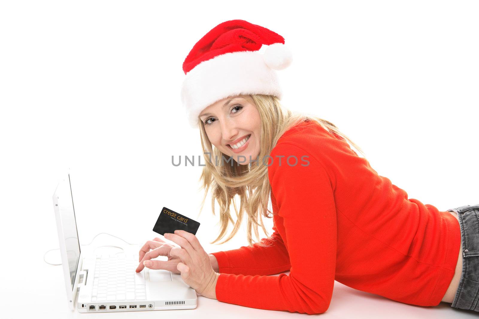 Girl using a card to shop safely  online.  She has a card in one hand and is looking up and smiling.  Change the text or add in your own card or credit card.