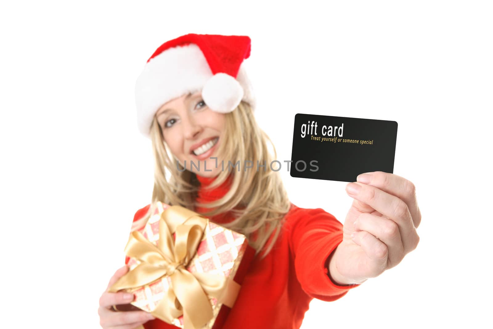 A woman holding a gift and outstretched arm showing a gift card, credit card or other card or object.  Focus is the hand and card.  Change the card or text to suit your needs.