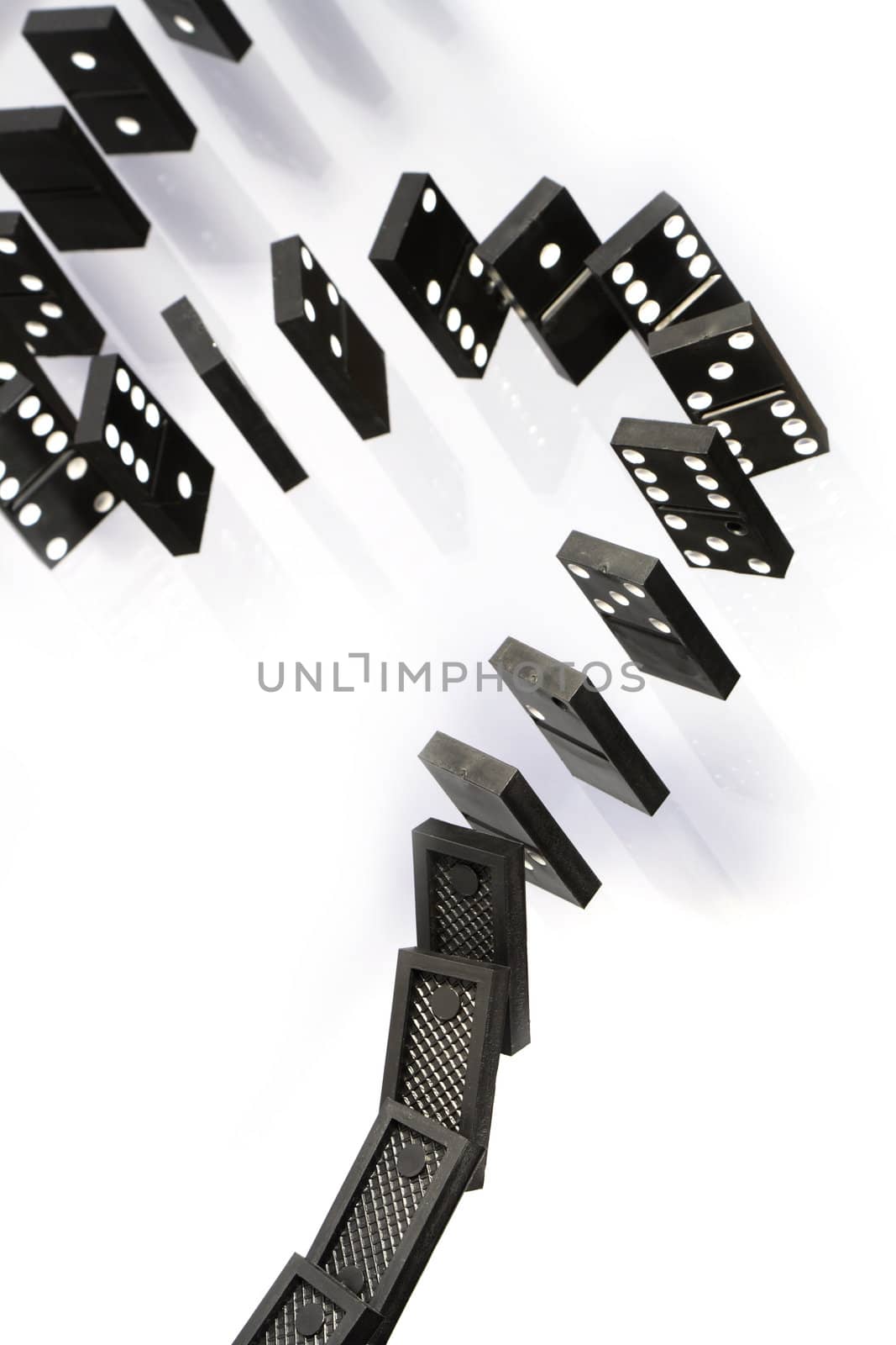 A stack of black dominoes falling on white background
