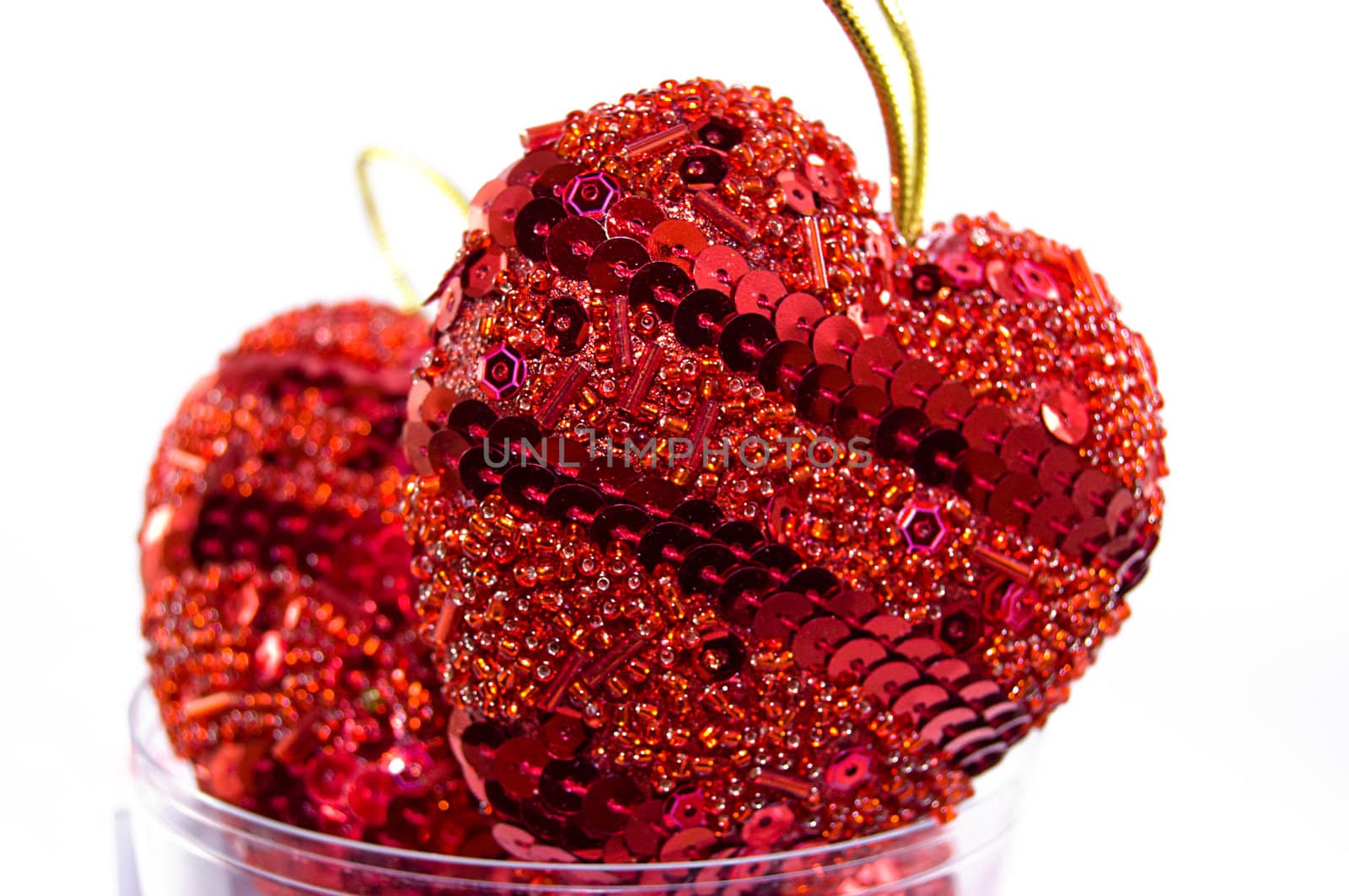 Two red hearts in beads over white