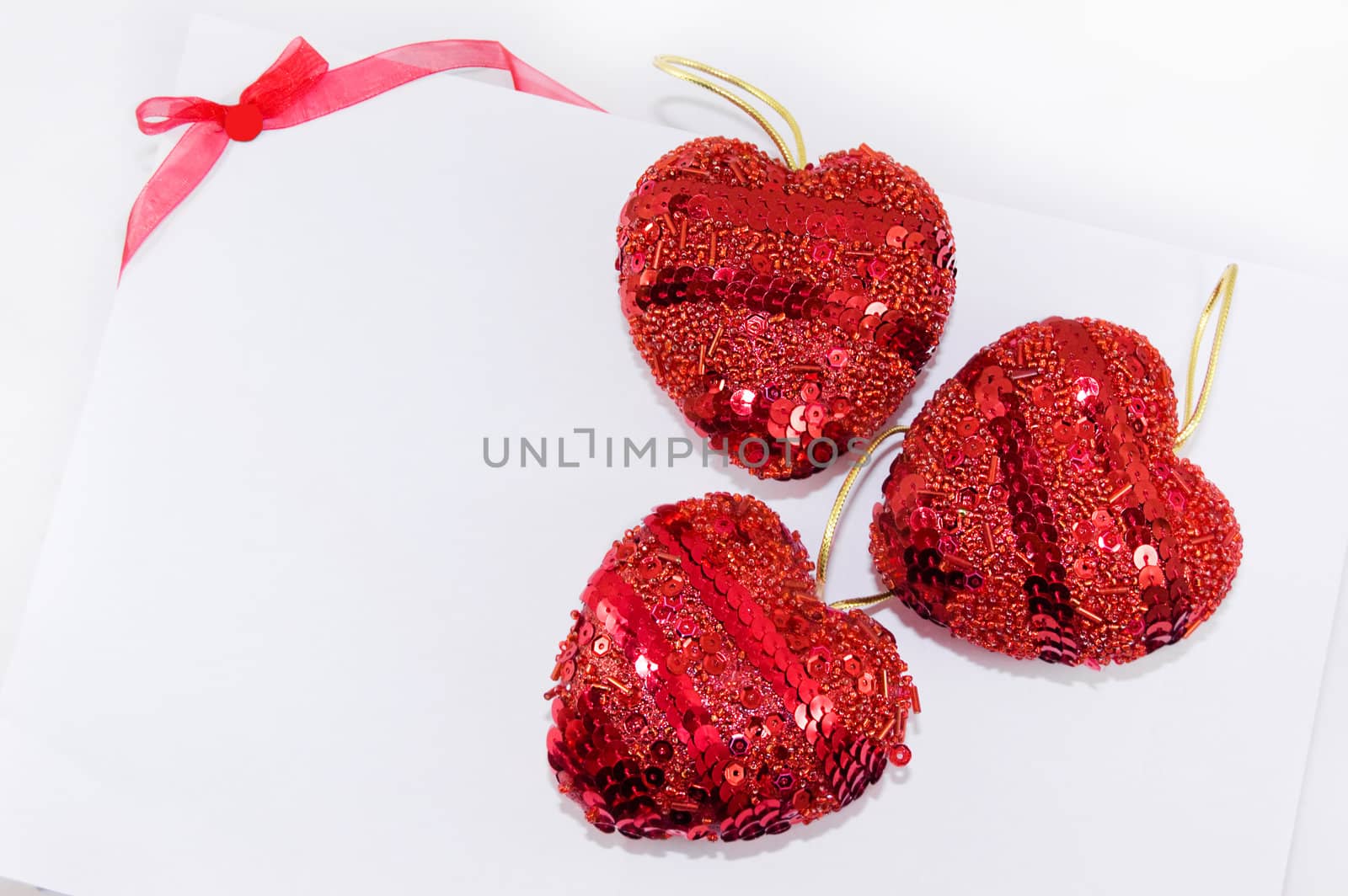 Red hearts and ribbon on white background, may be used as celebration card