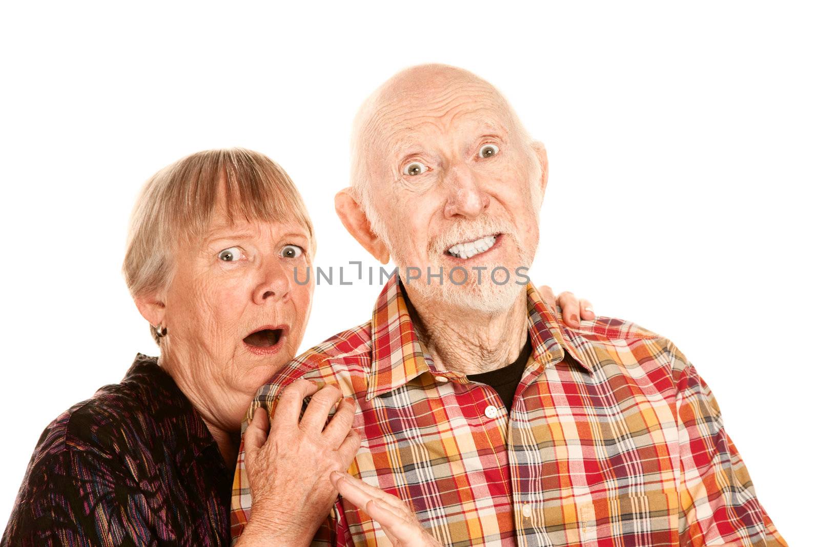 Senior couple with shocked expressions on their faces
