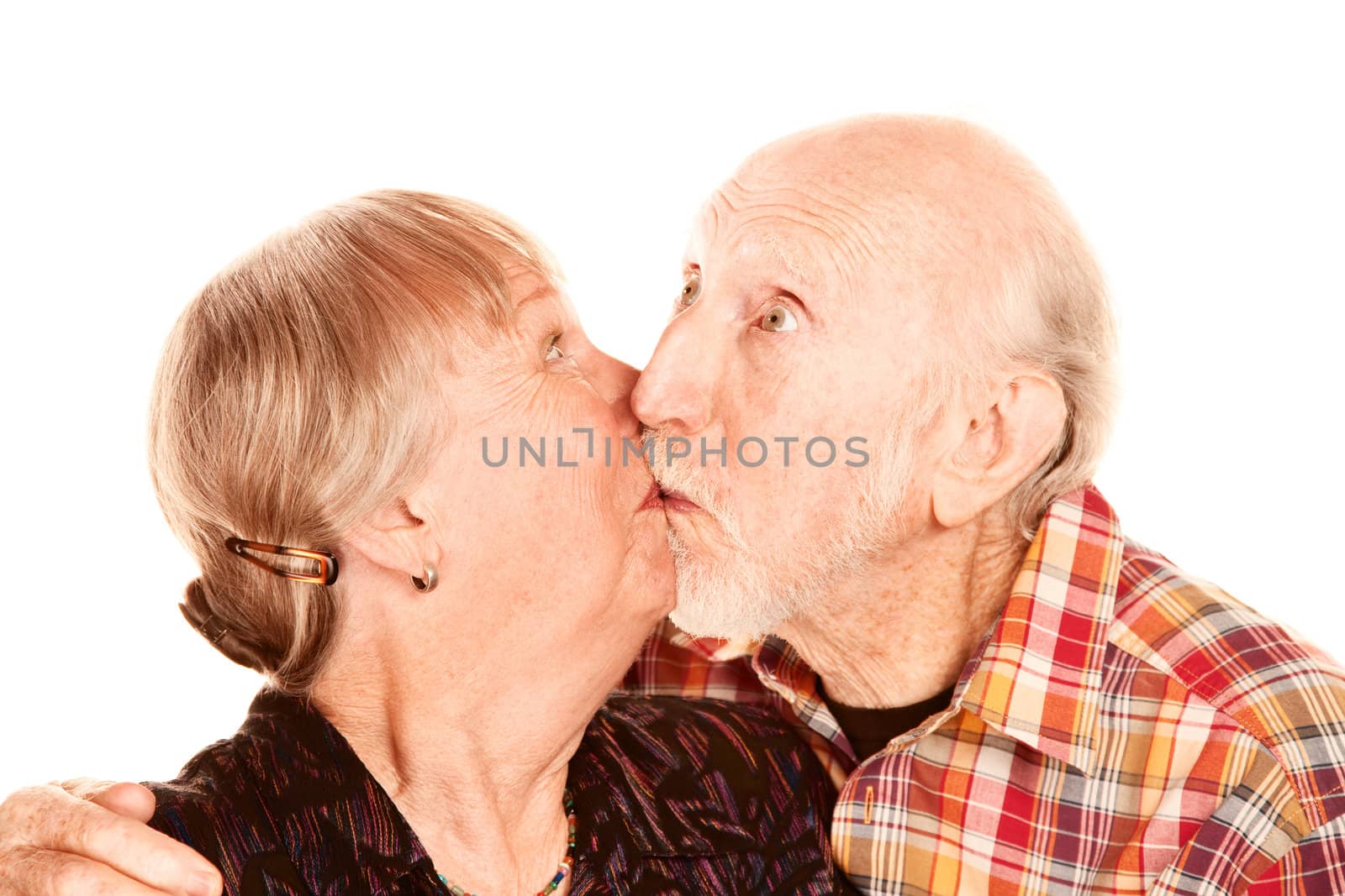 Happy senior couple on white background kissing