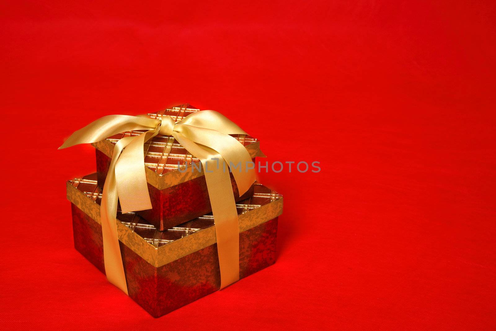Gift boxes tied up with gold satin ribbon for Christmas, a birthday or other special occasion
