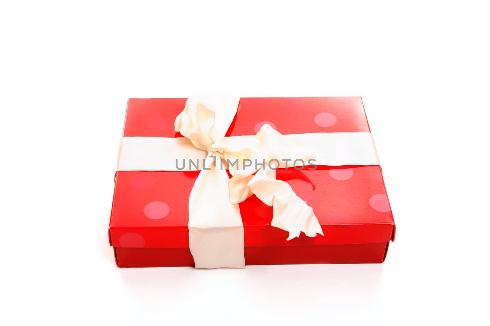 Red box tied up with cream wired satin ribbon