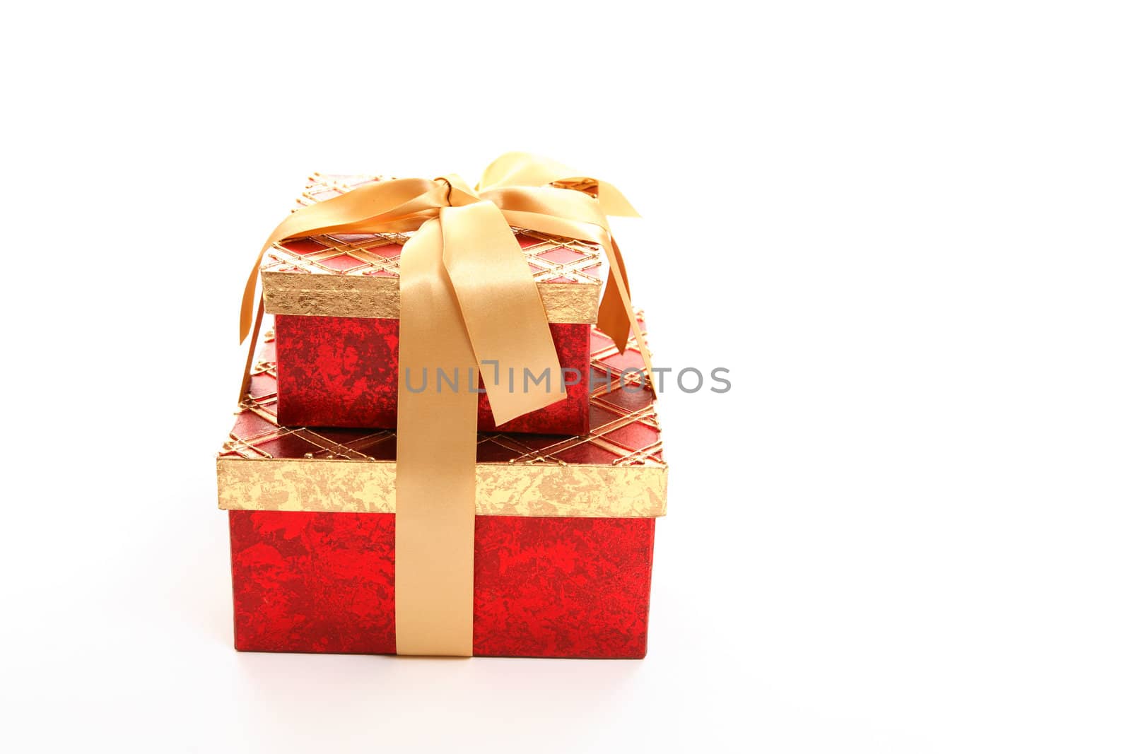 Red and gold giftboxes tied up with ribbon  on white.