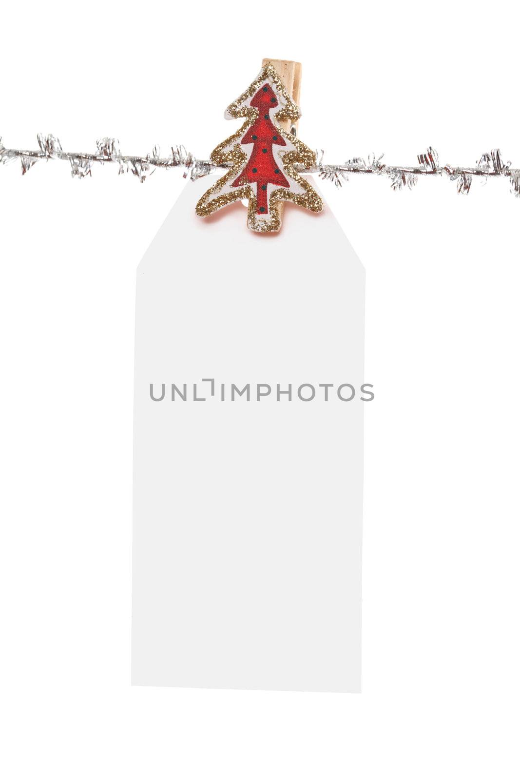 One single large  christmas tag  pegged to a silver line