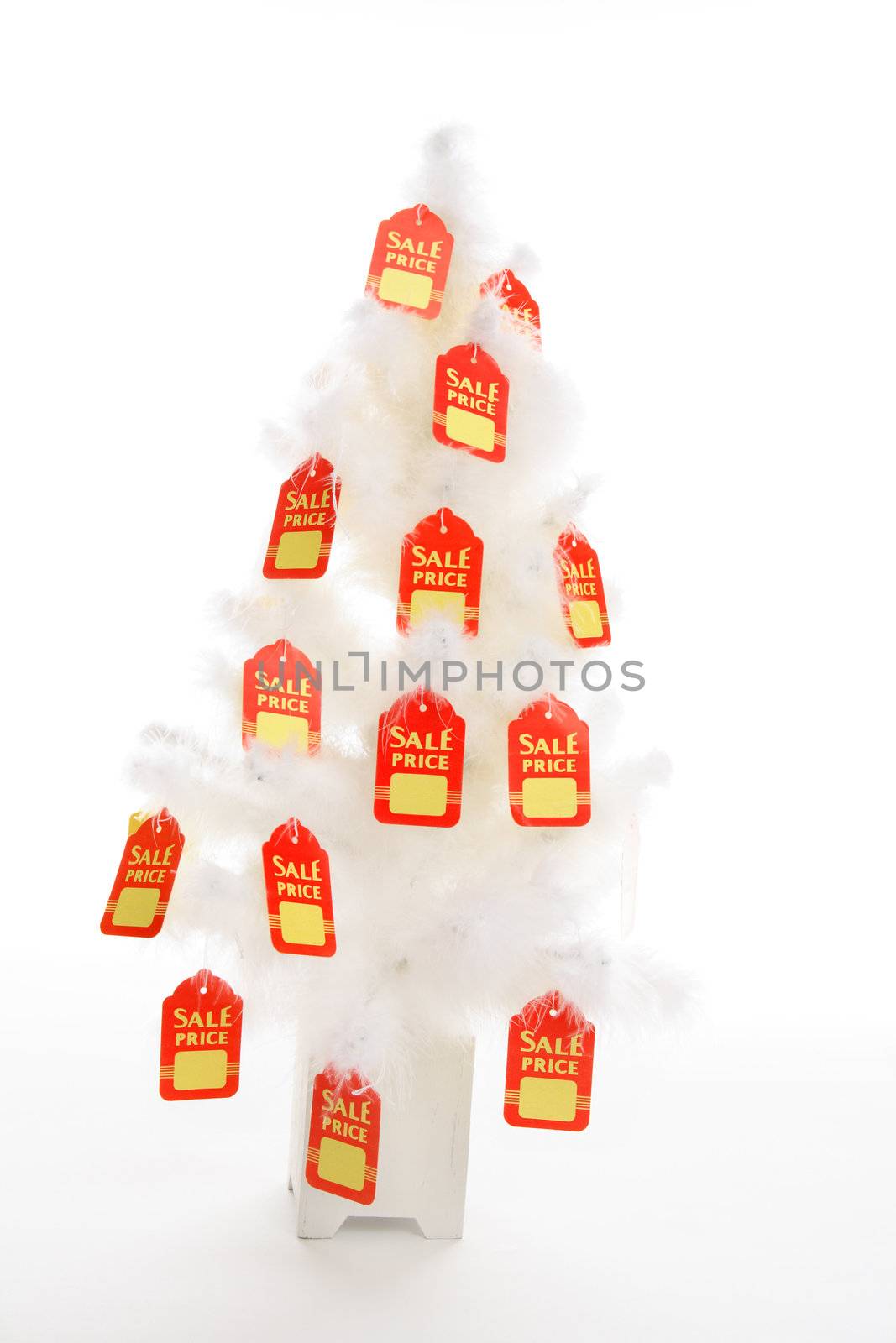 Red and yellow sale tags hang from a white Christmas tree. concept.  Change it to suit your needs.