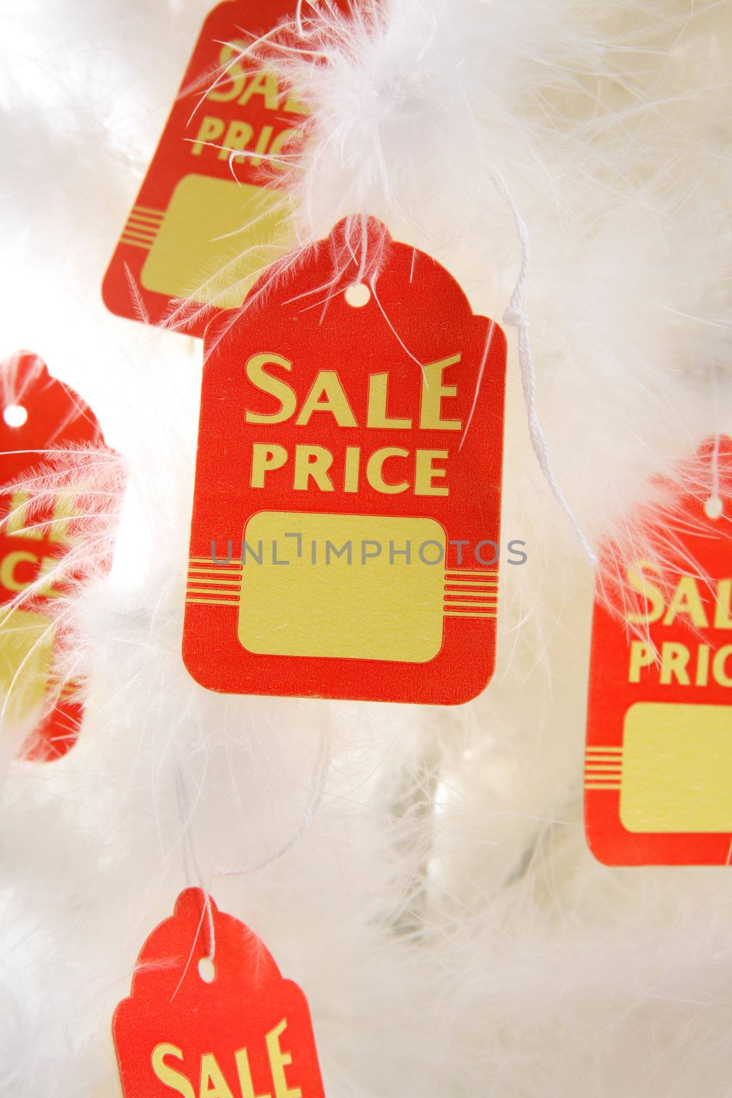 Sale tags hang from white Chirstmas tree