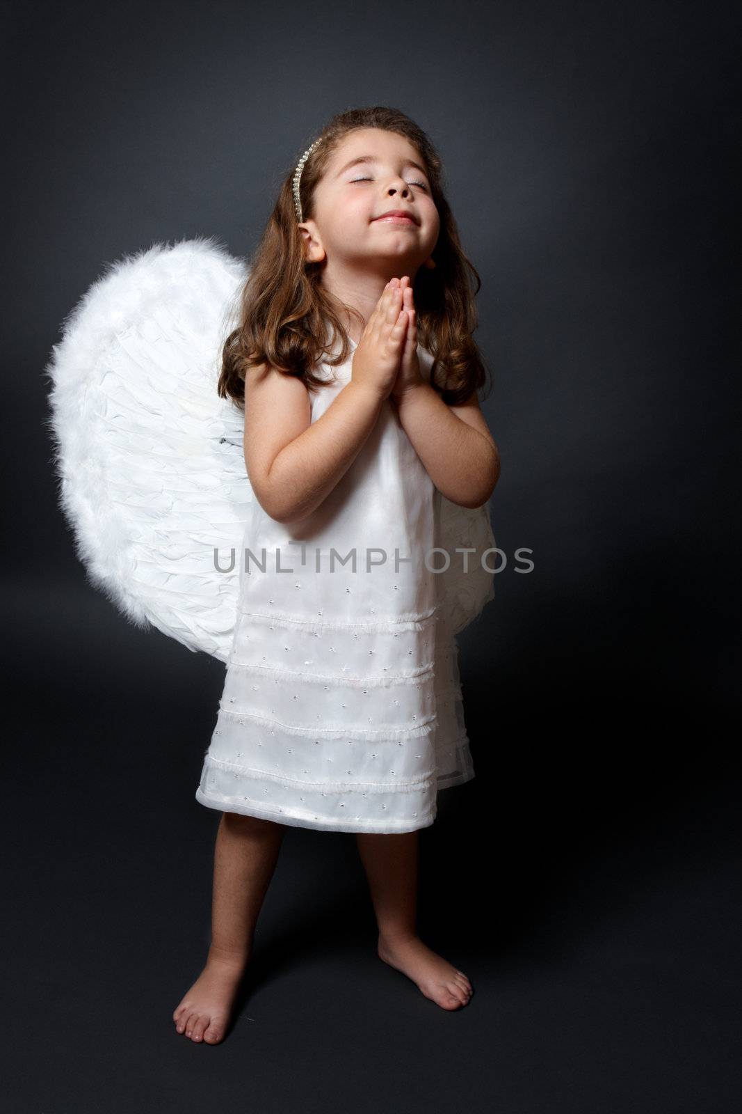 Praying angel with hands together in worship by lovleah