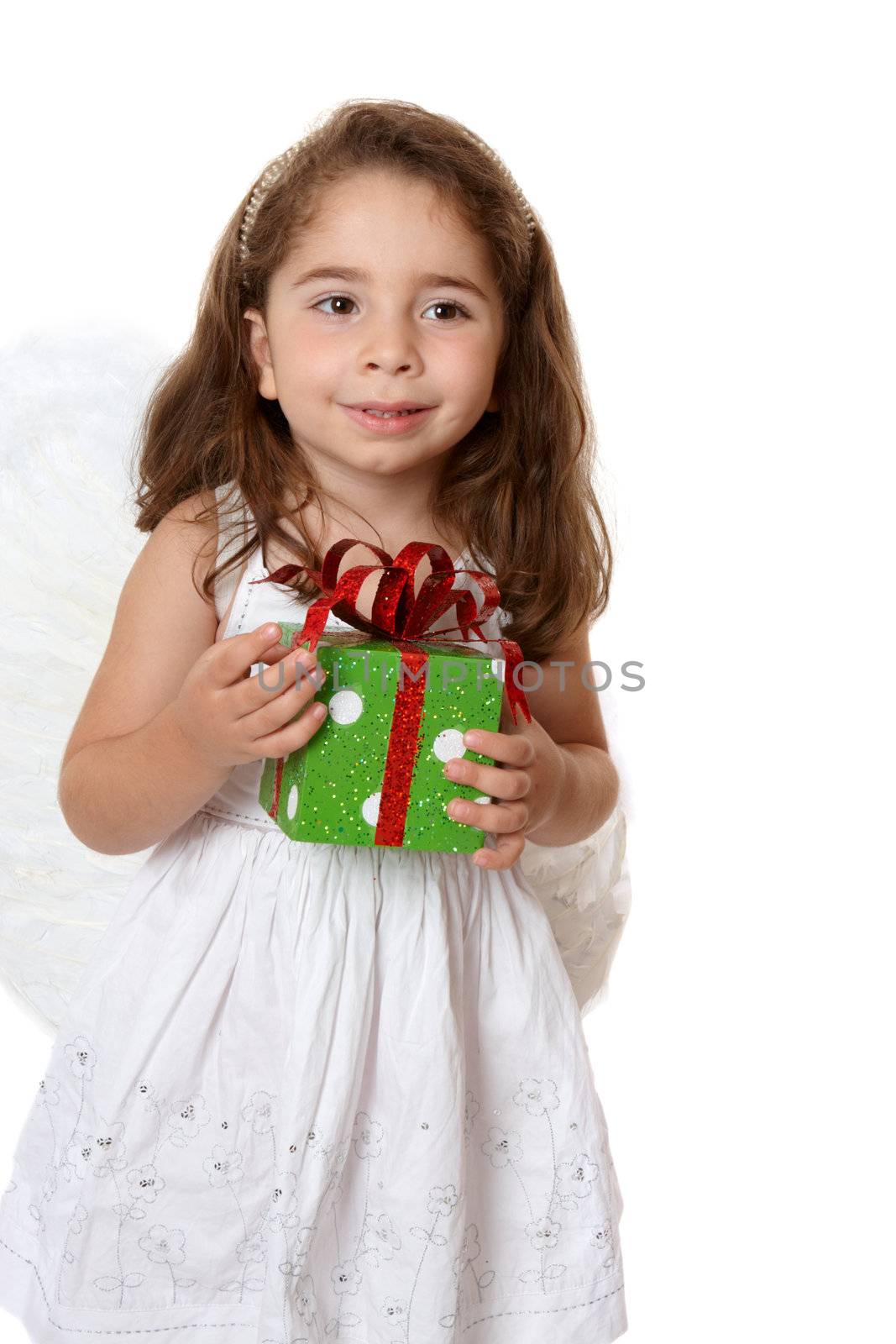 Beautiful little girl wearing a white dress and wings is holding a present.