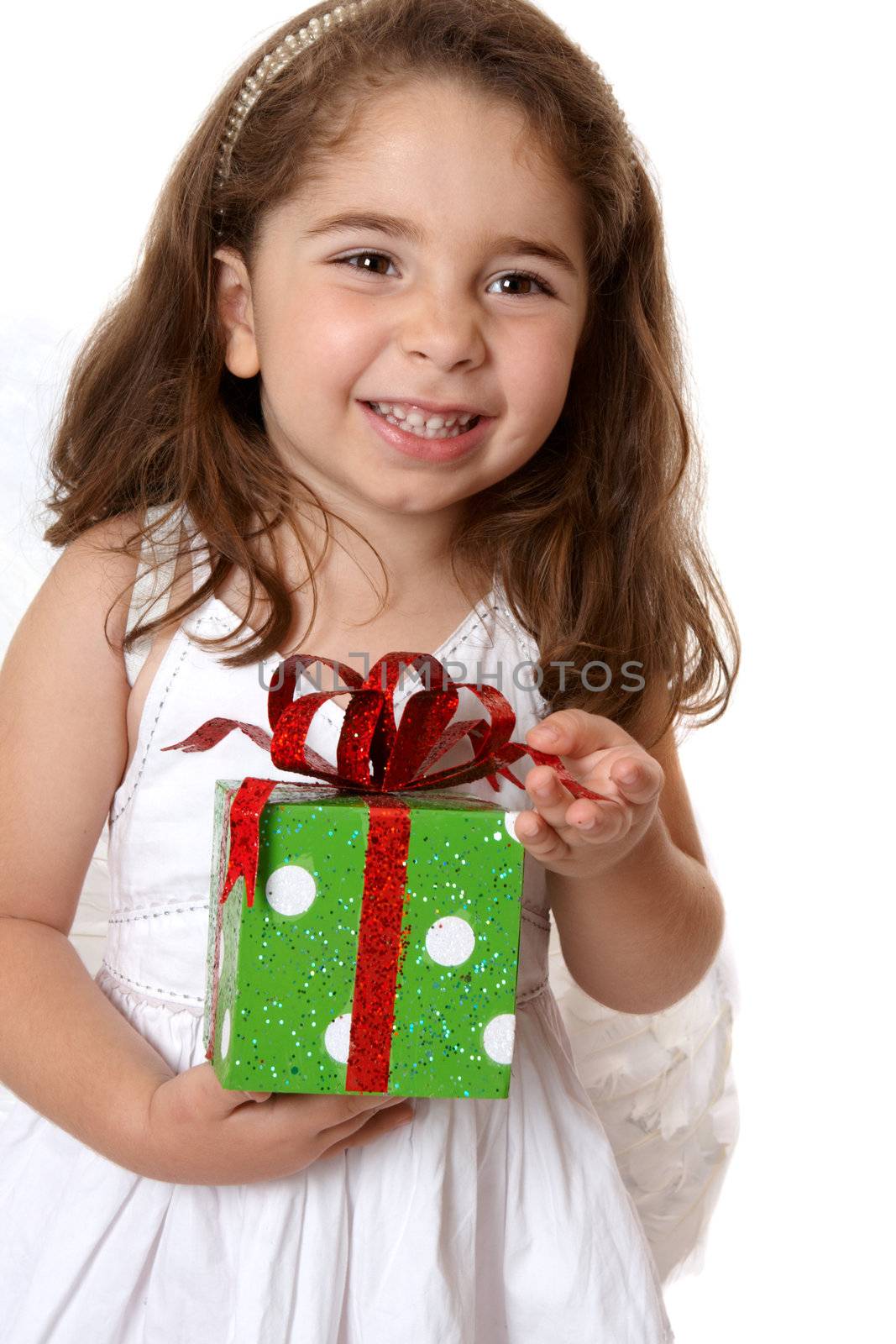 Pretty little girl holding a present and smiling.   