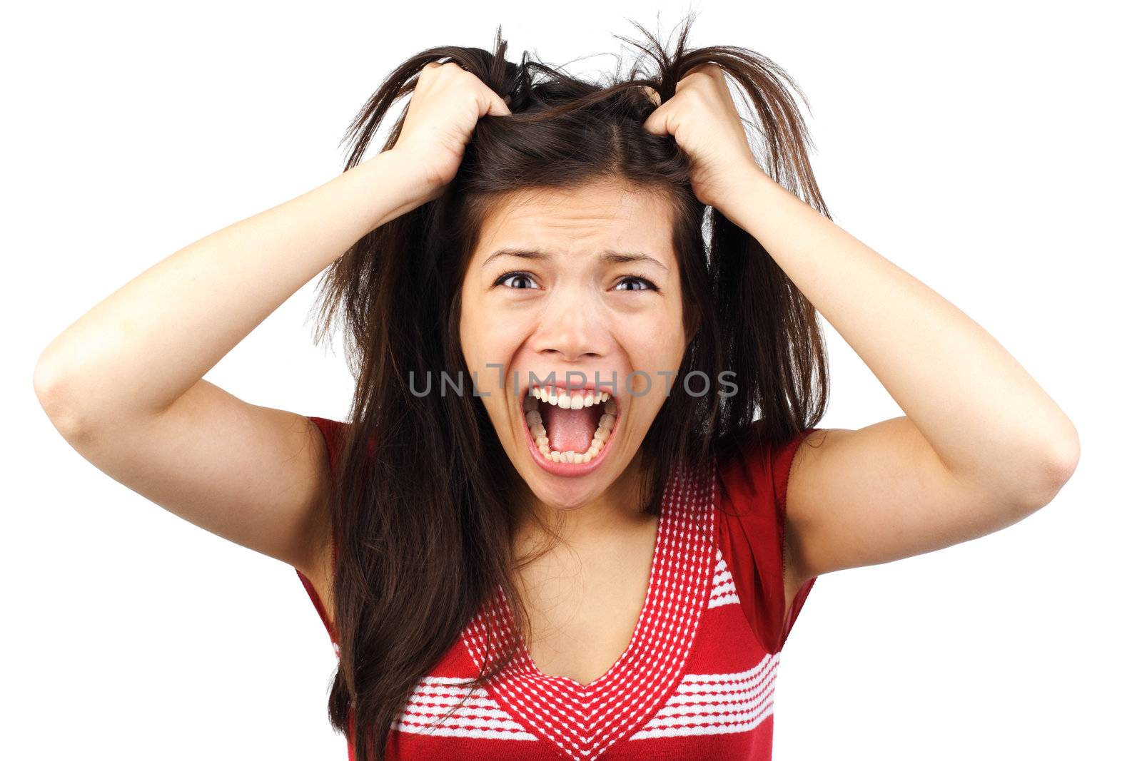 Frustrated and angry mad woman going crazy hands pulling her hair. Isolated on white background