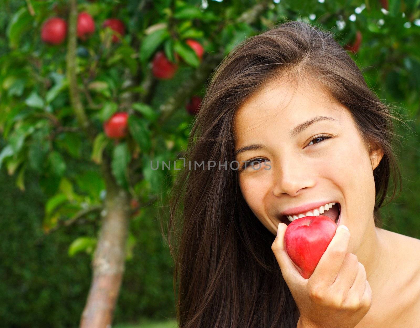 Woman eating red apple by Maridav