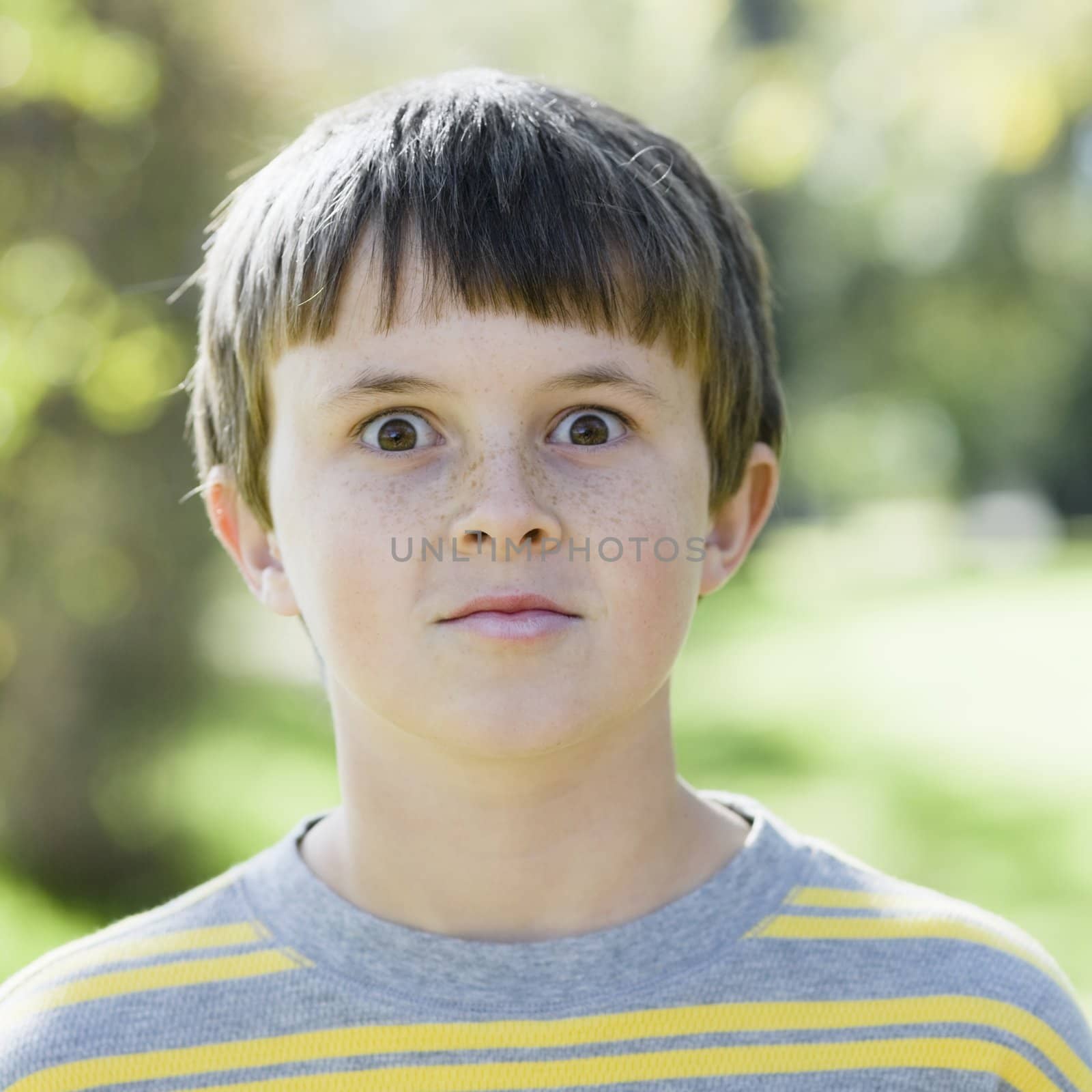 Portrait of a Cute Young Boy Outdoors making a Funny Look With His Eyes