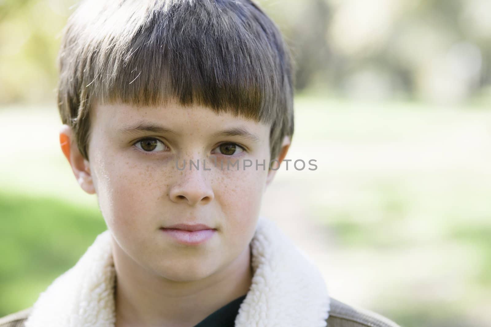 Portrait of a Cute Young Boy Looking Directly To Camera