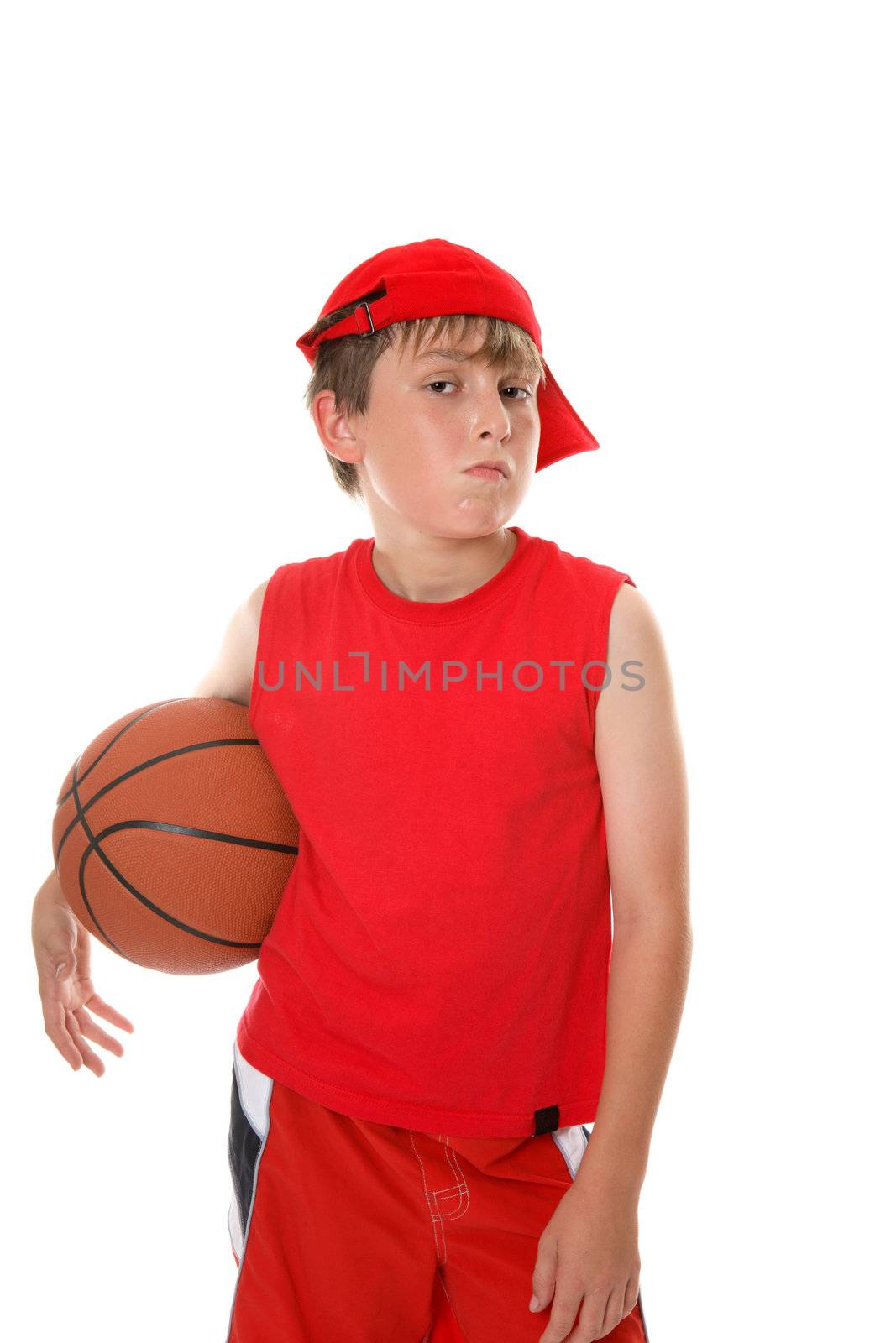 A hot and sweaty young player with attitude stands with a basketball.