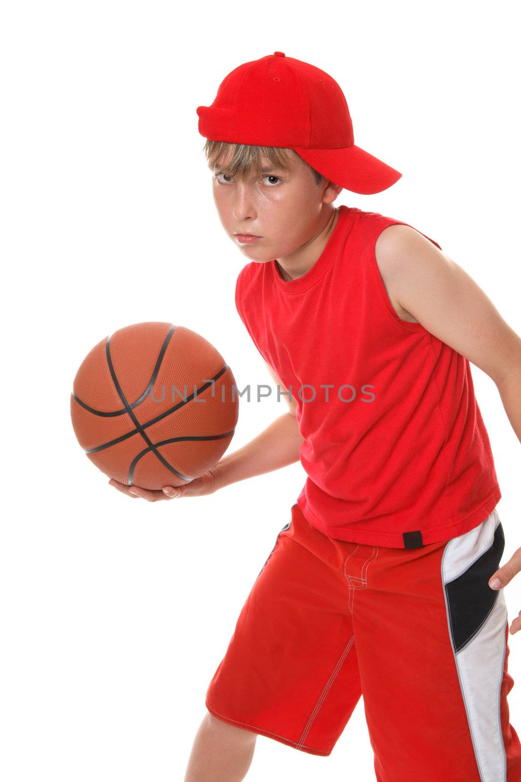 A boy playing with a basketball.