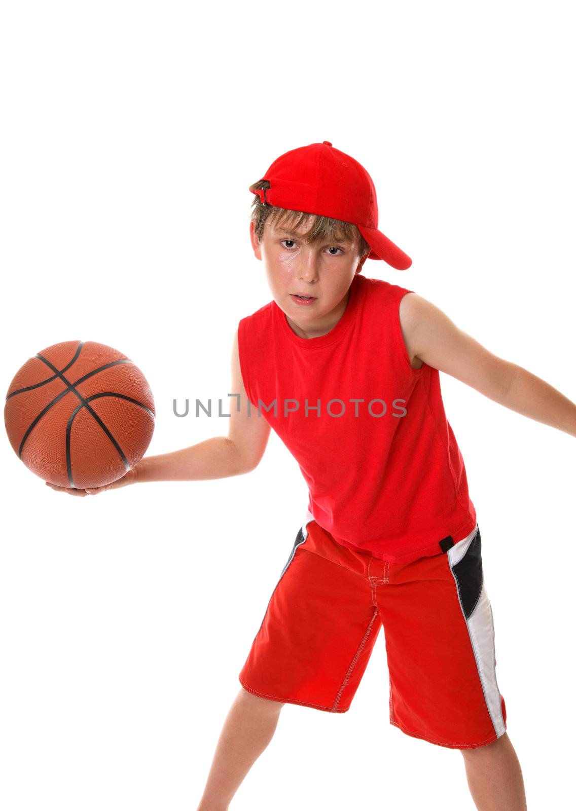 An active boy plays around with a basketball