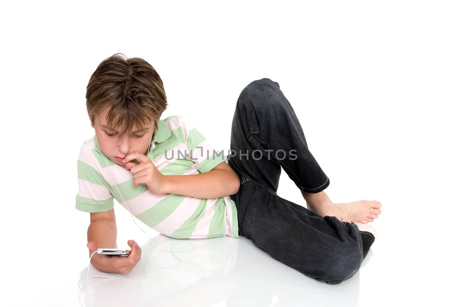 Child relaxing with electronic music player.