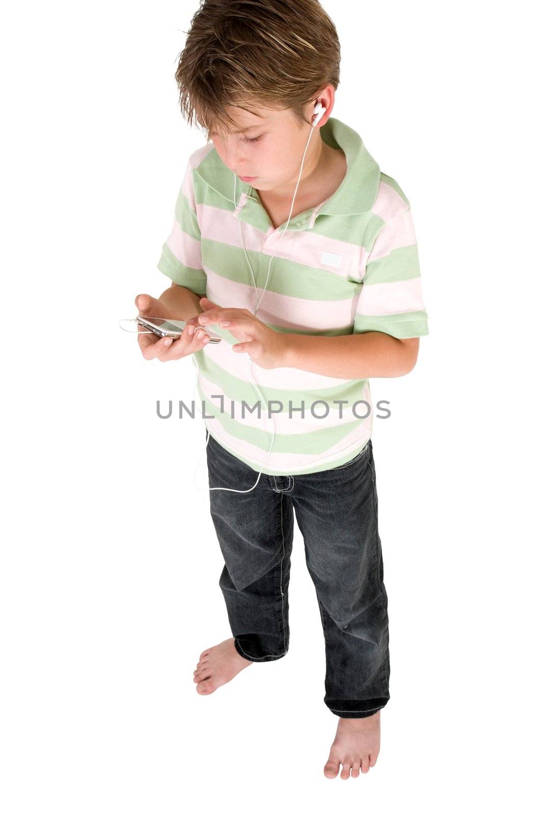 Standing young child using a music mp3 player