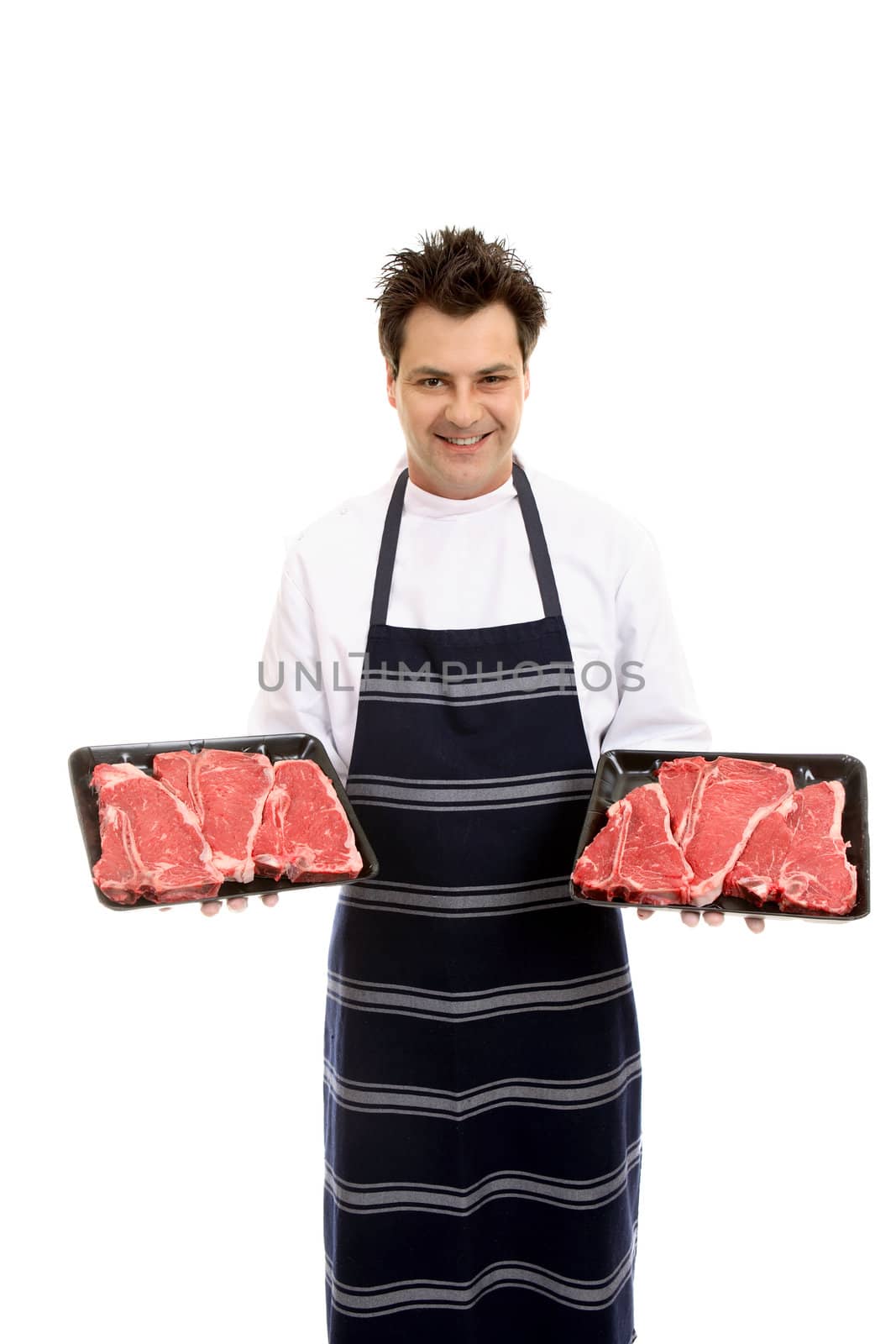 Butcher holding two trays of t-bone steak.