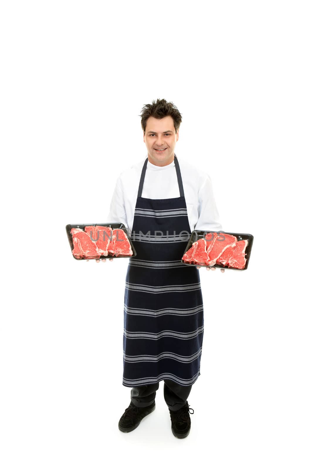 Friendly butcher holding trays of tender steak.