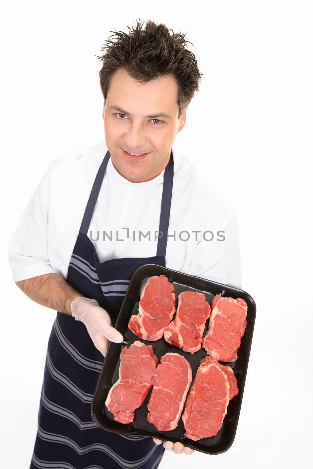 Butcher showing a tray of tender scotch filet steak.