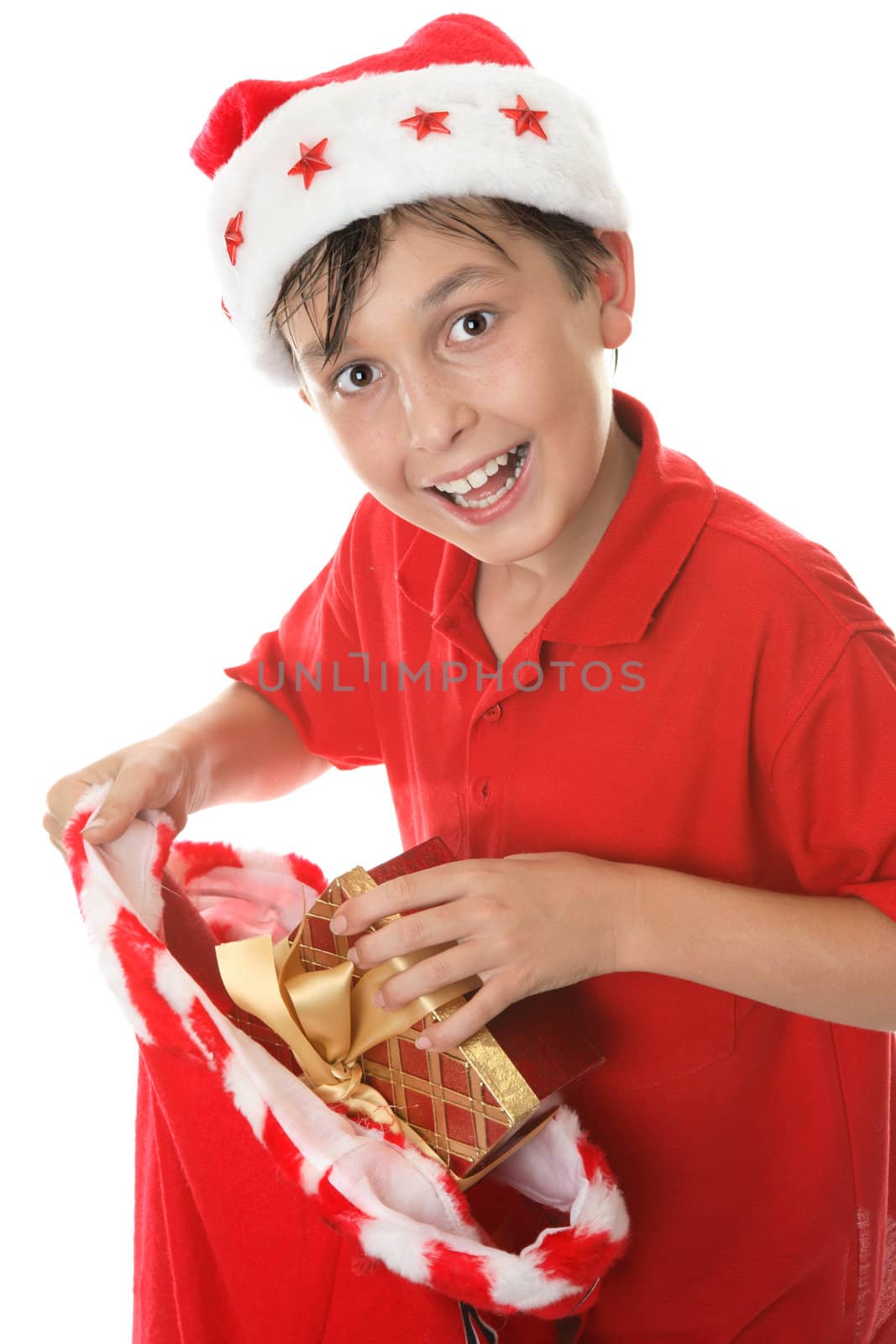 A jovial, child takes presents out at Christmas