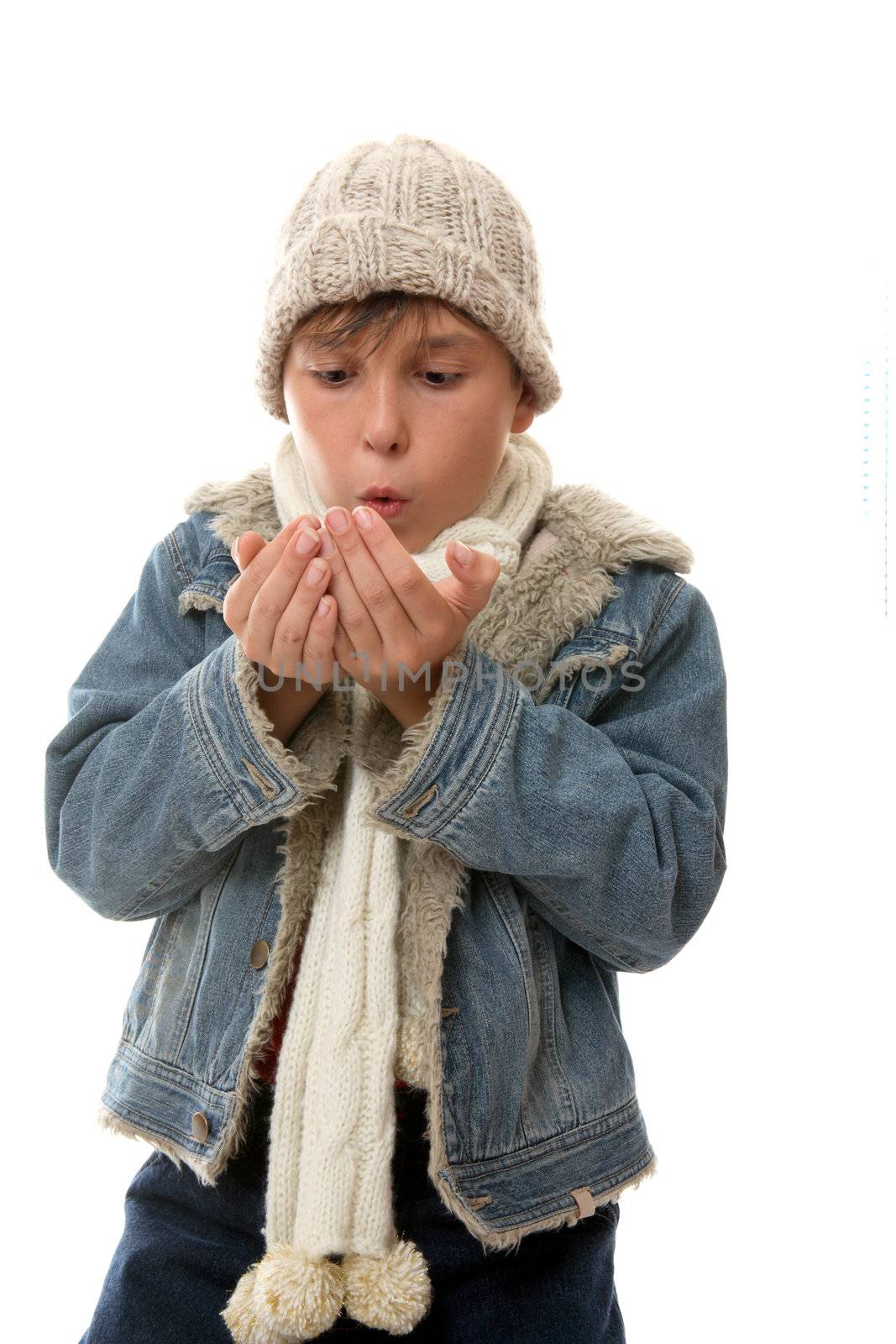 Child blowing on hands to warm them up.
