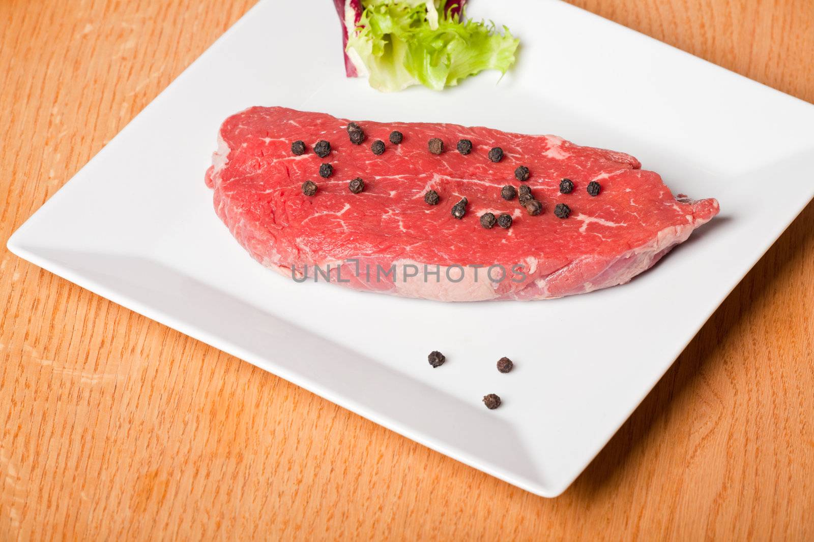 raw steak prepared for cooking by bernjuer