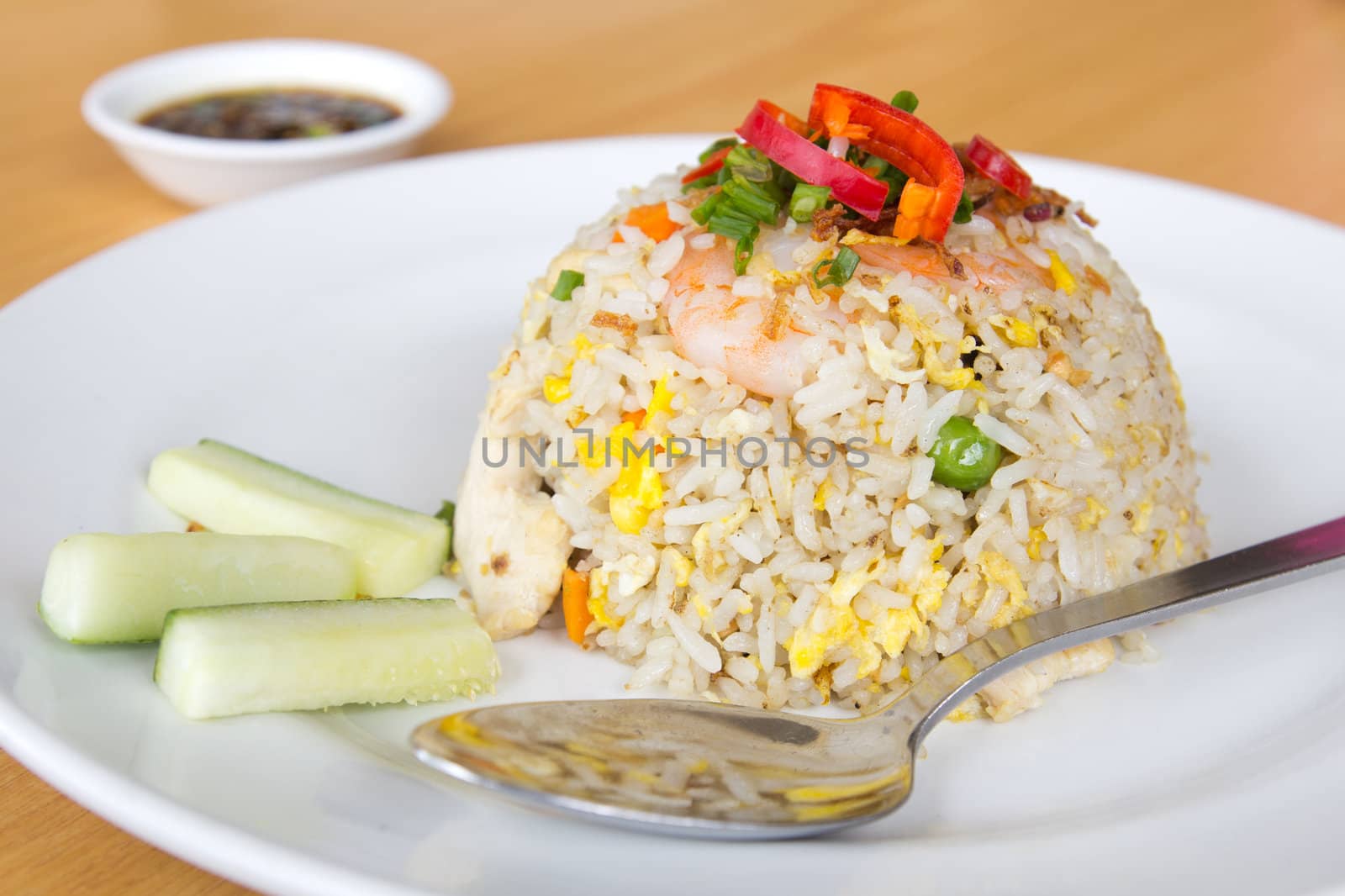 Plate of oriental fried rice with shrimp, chicken and egg