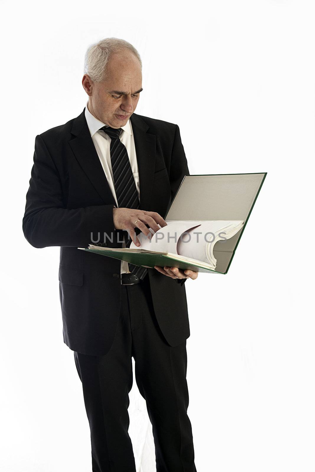 A concerned businessman who looks into a file folder