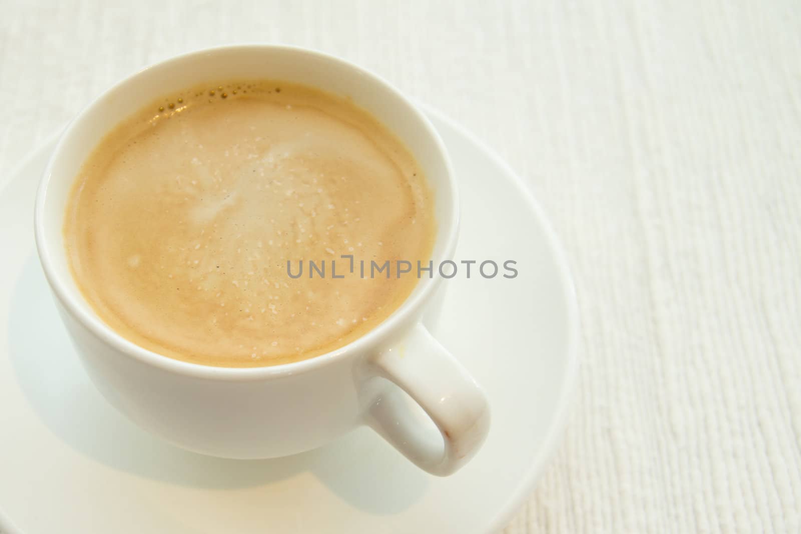 Picture of a cup of coffee on white cloth