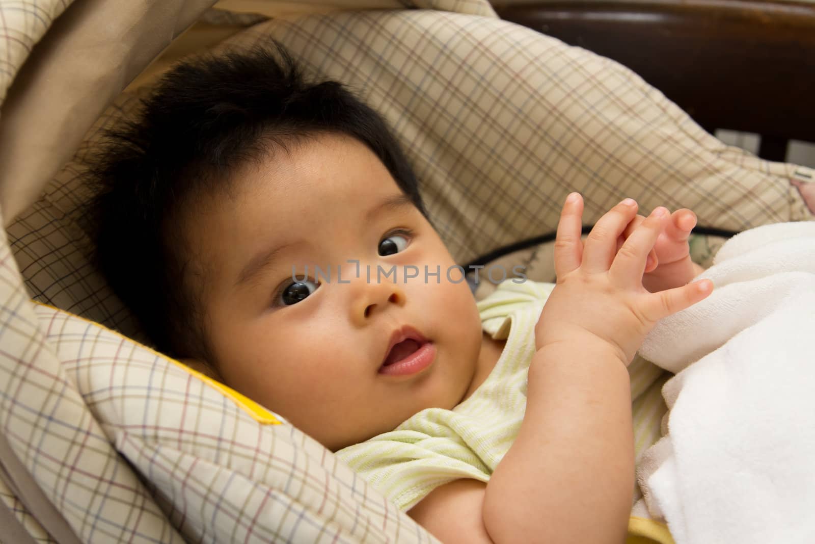 Asian baby girl in a car seat