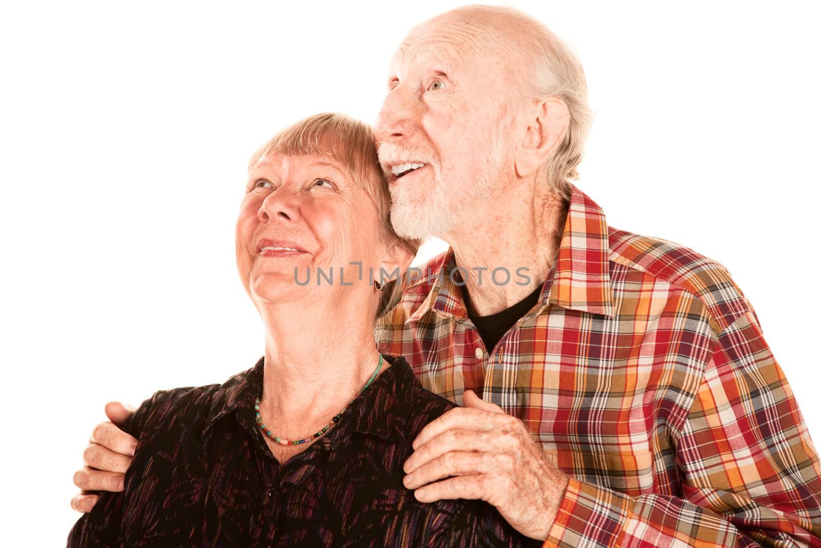 Happy senior couple looking up to the left