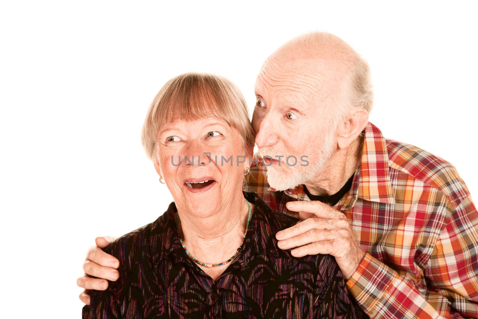 Happy senior couple pointing and looking left