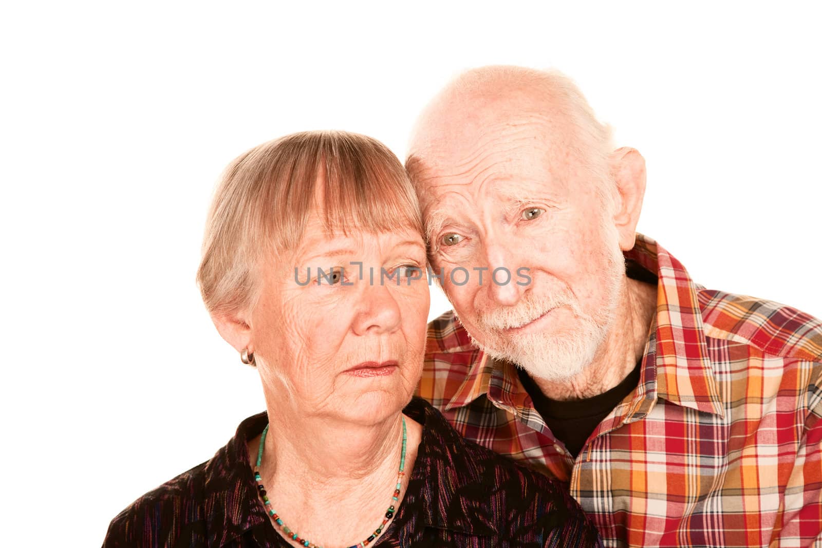 Portrait of concerned senior couple on white background