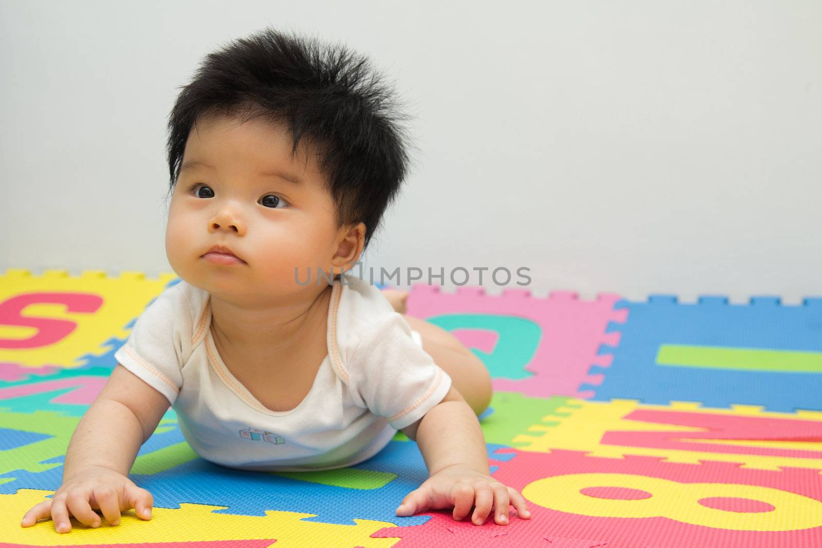 Portrait of a little Asian baby girl crawling on floor