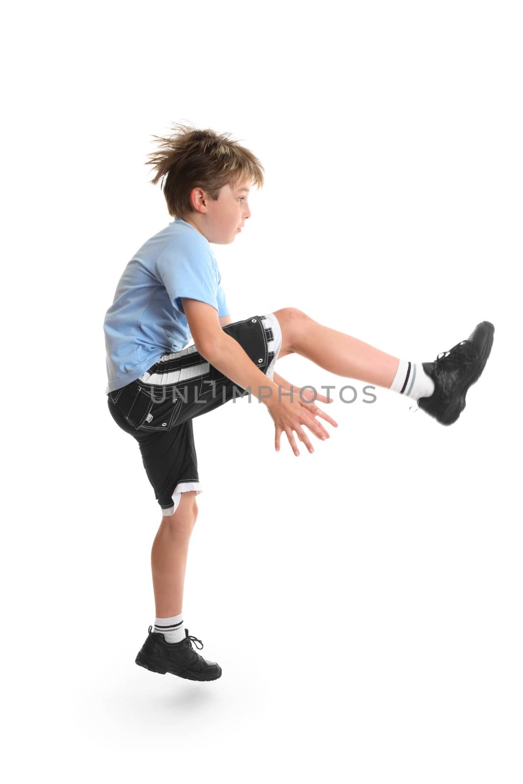 Healthy young child doing fitness exercises.