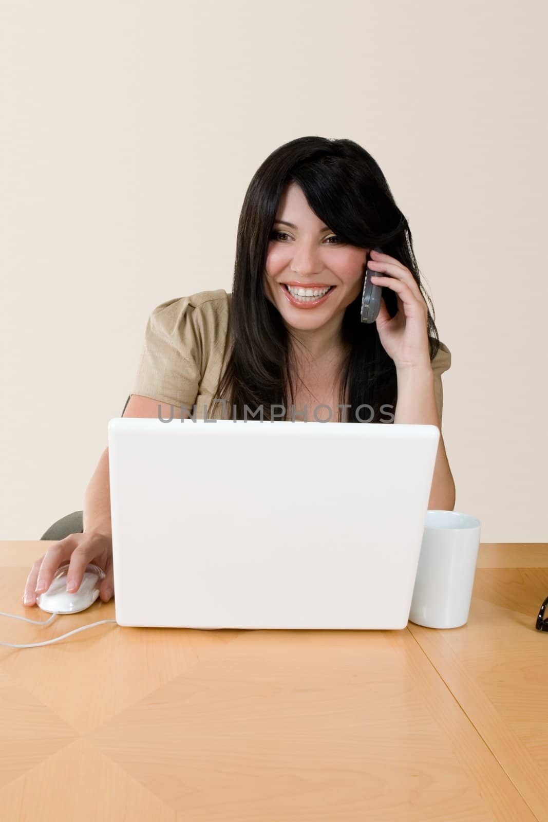 A woman at work using the telephone.