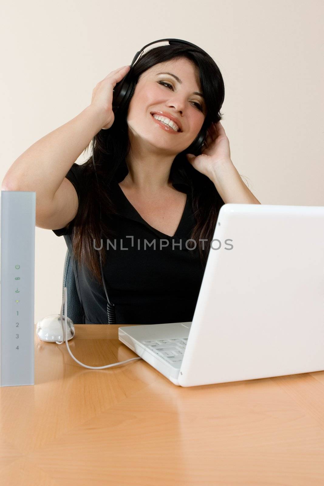 A woman listens to streaming music or video or music downloaded from the internet.