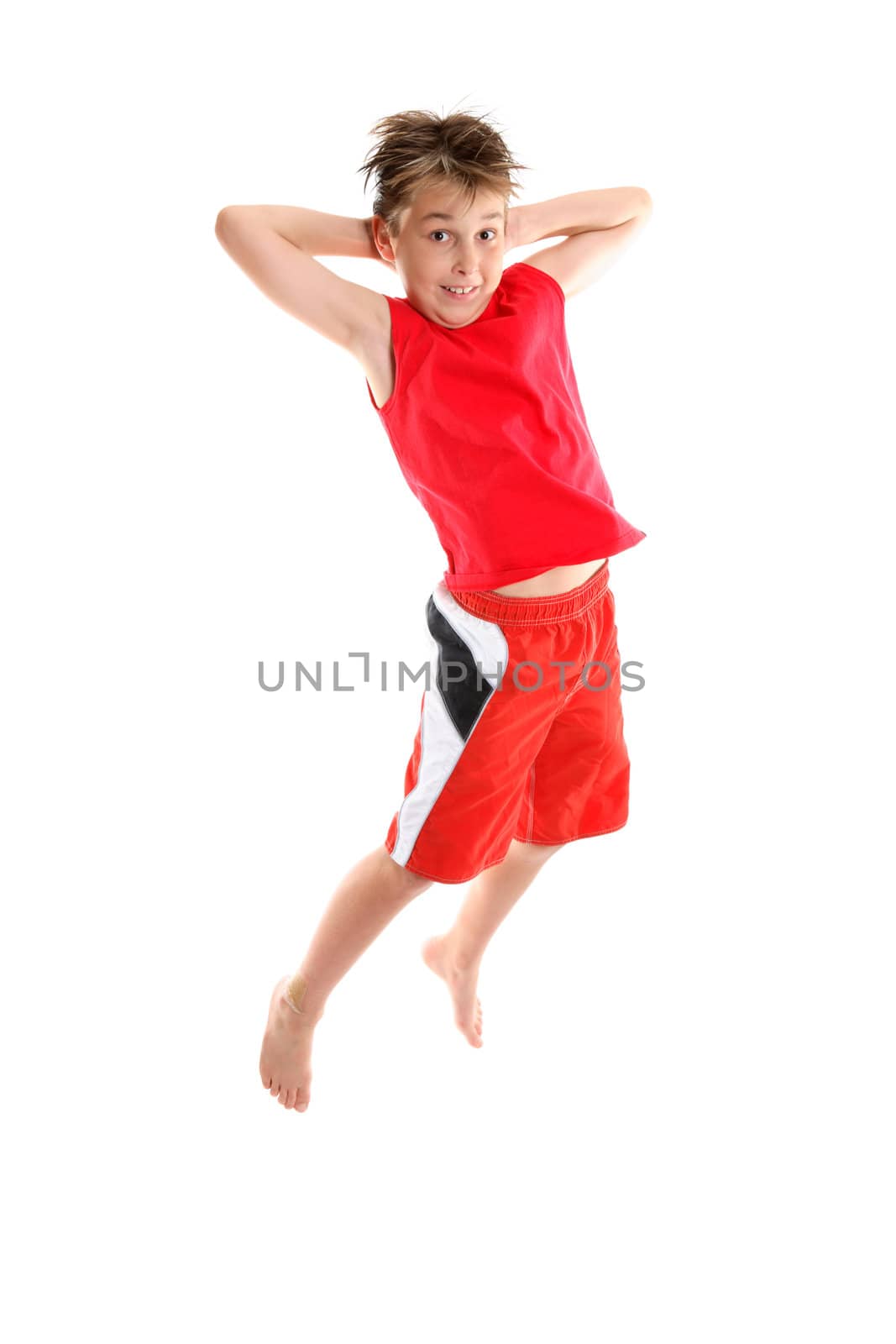 Boy jumping hands behind head by lovleah