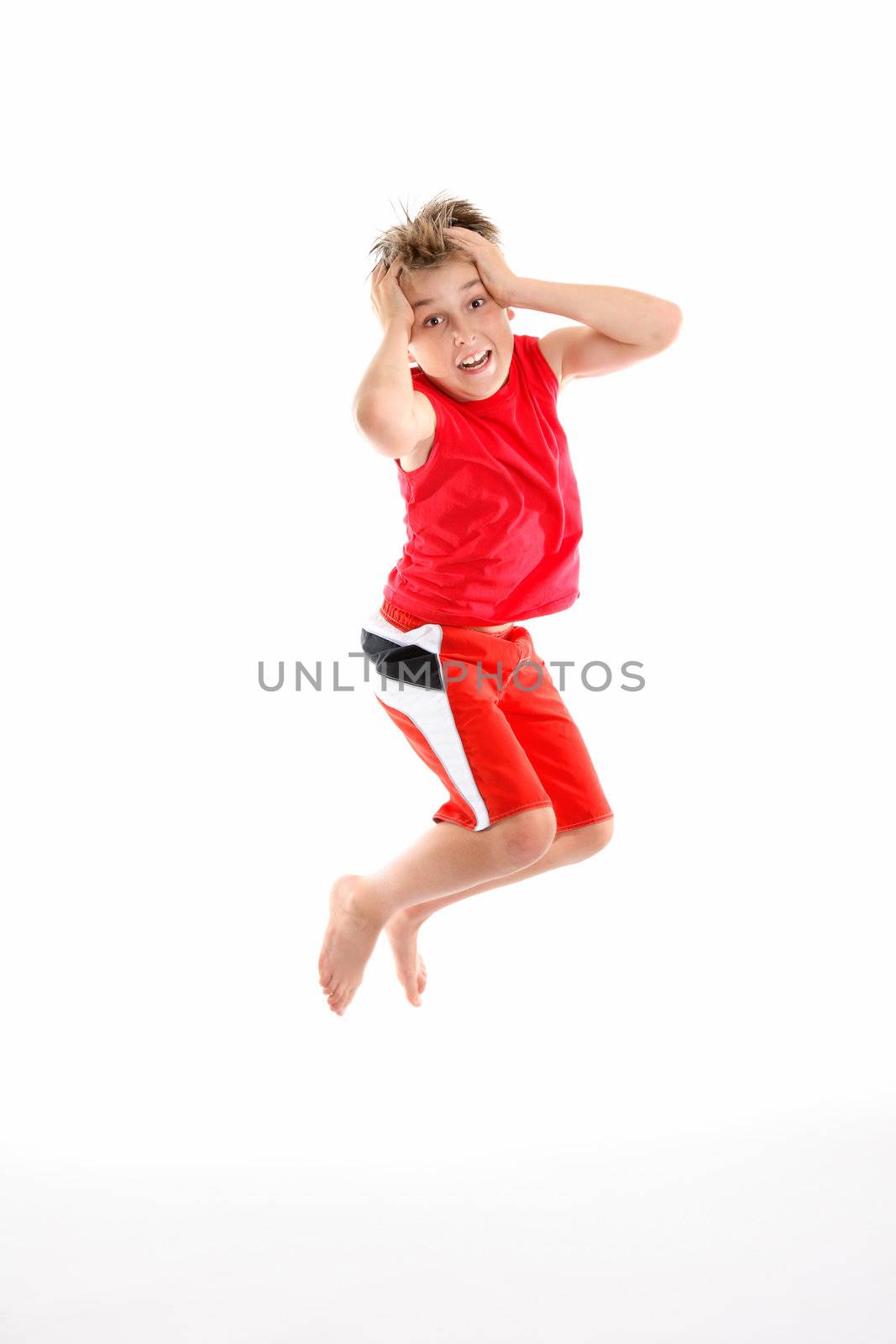 A panicked boy mid air grabs his head in fear or apprehension.