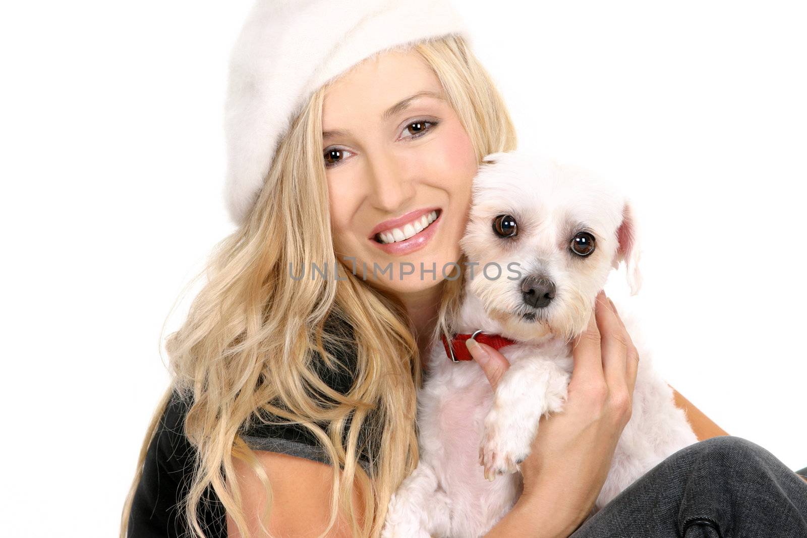 A sitting female hugging a small white dog
