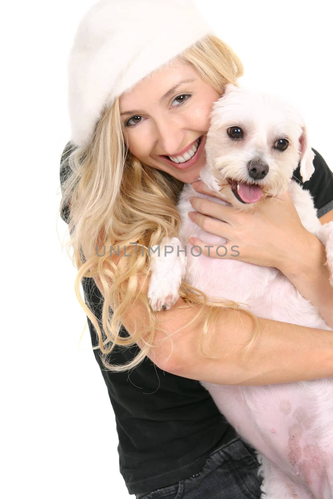 A smiling woman cuddling a cute lovable white dog